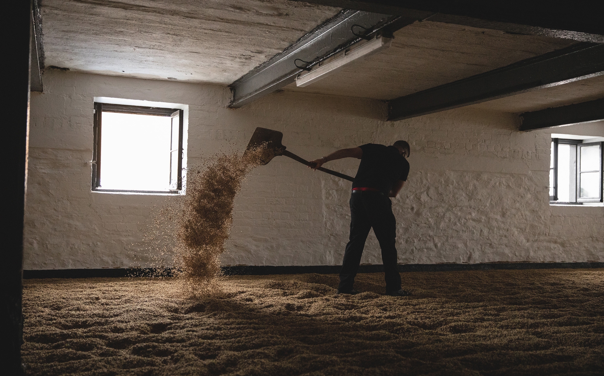 Bowmore Maltmen turning barley in Malt Barn