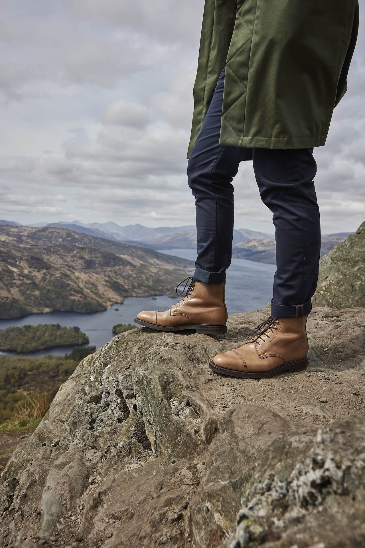 A man on a mountain wearing Crockett & Jones boots
