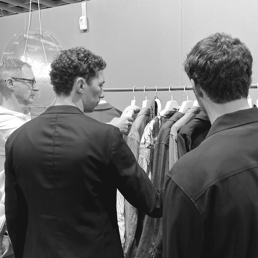 The Studio Graft team looking at clothes at Pitti Uomo