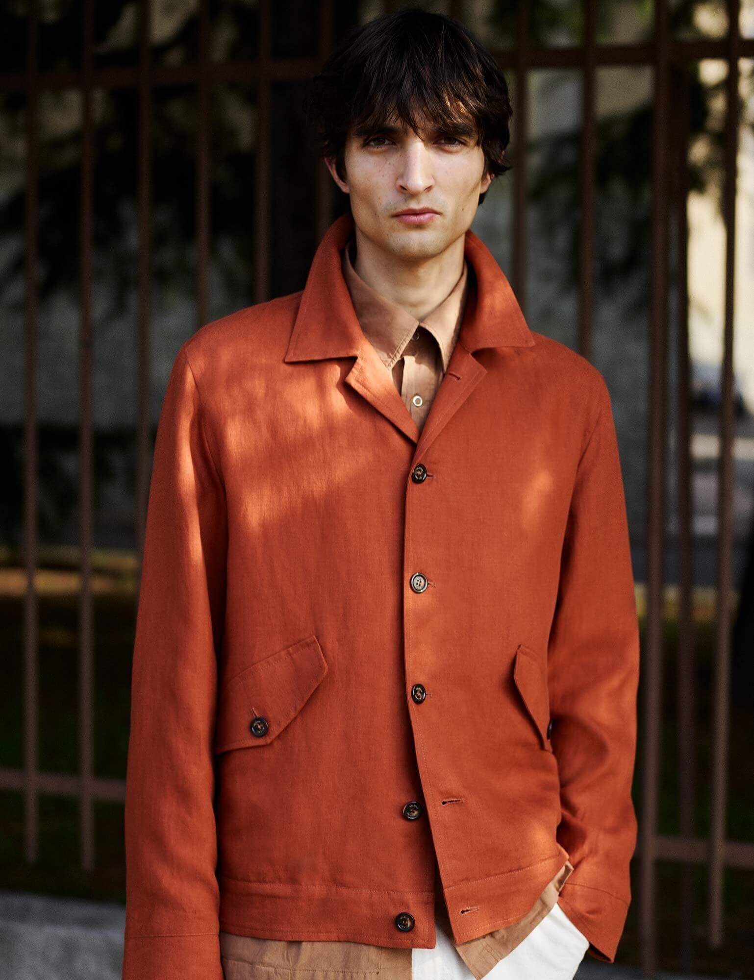A model wearing an orange jacket from Valstar Milano