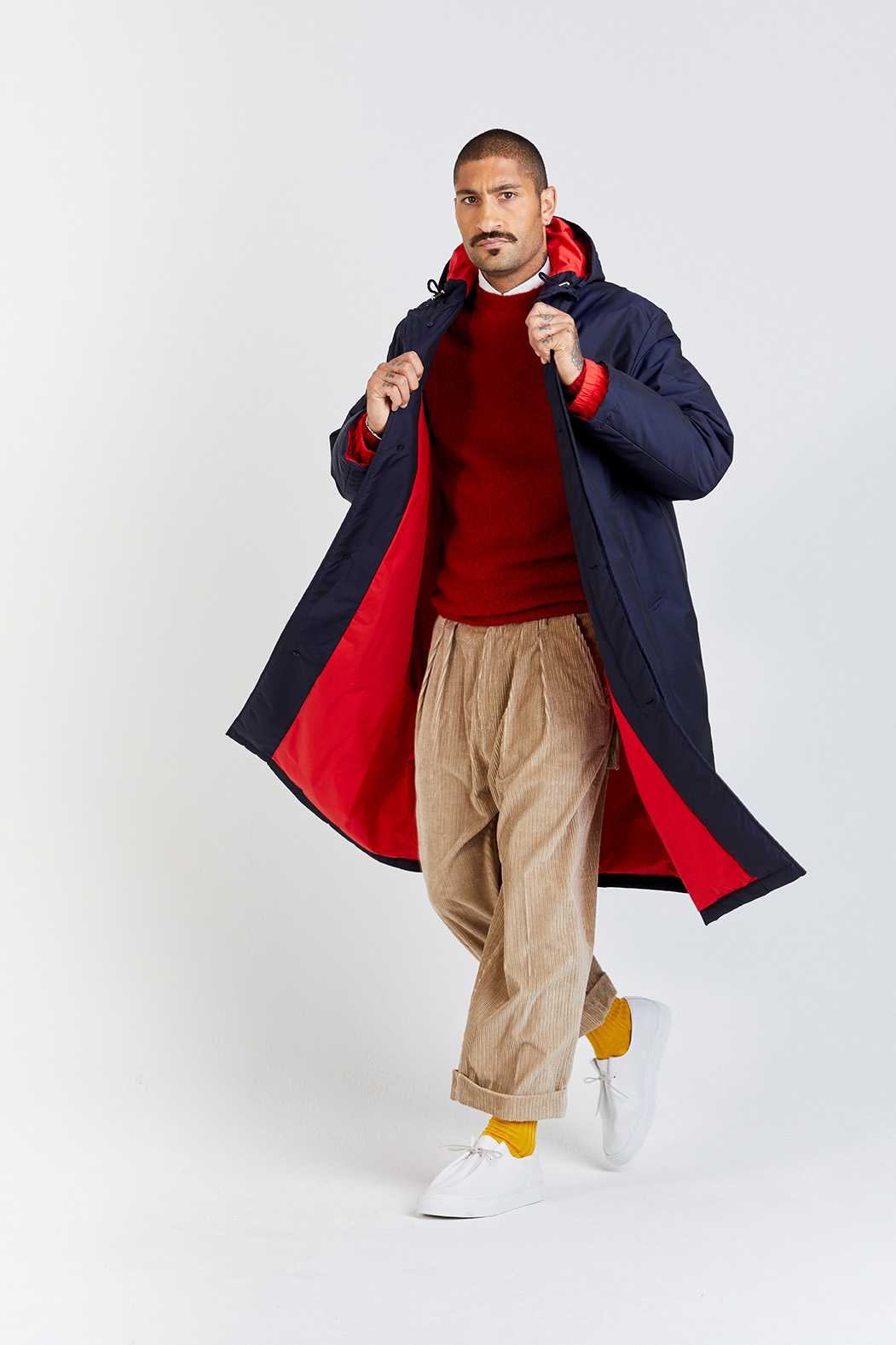 Mackintosh outife with blue coat, red jumper, and corduroy trousers