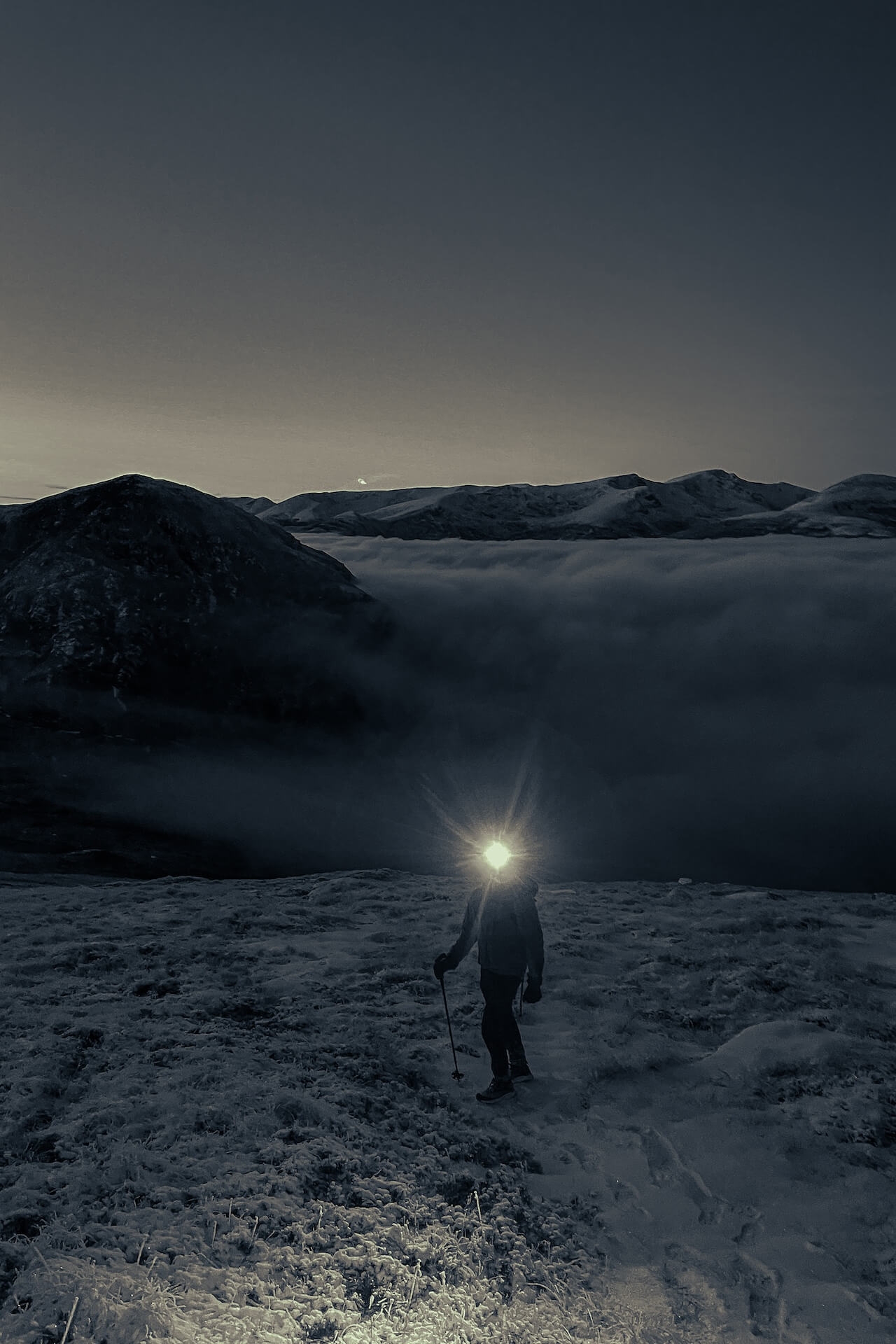 A member of the Studio Graft team climbing a mountain in the dark